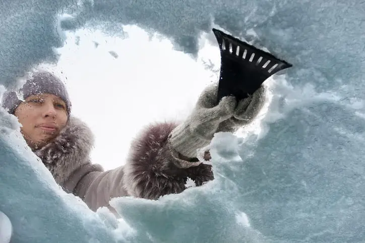 Scraping ice off windshield