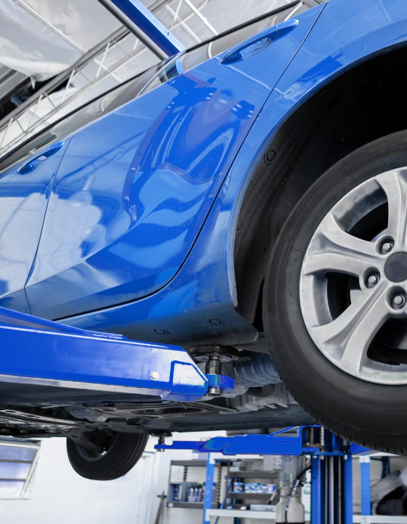 Blue car on lift in shop